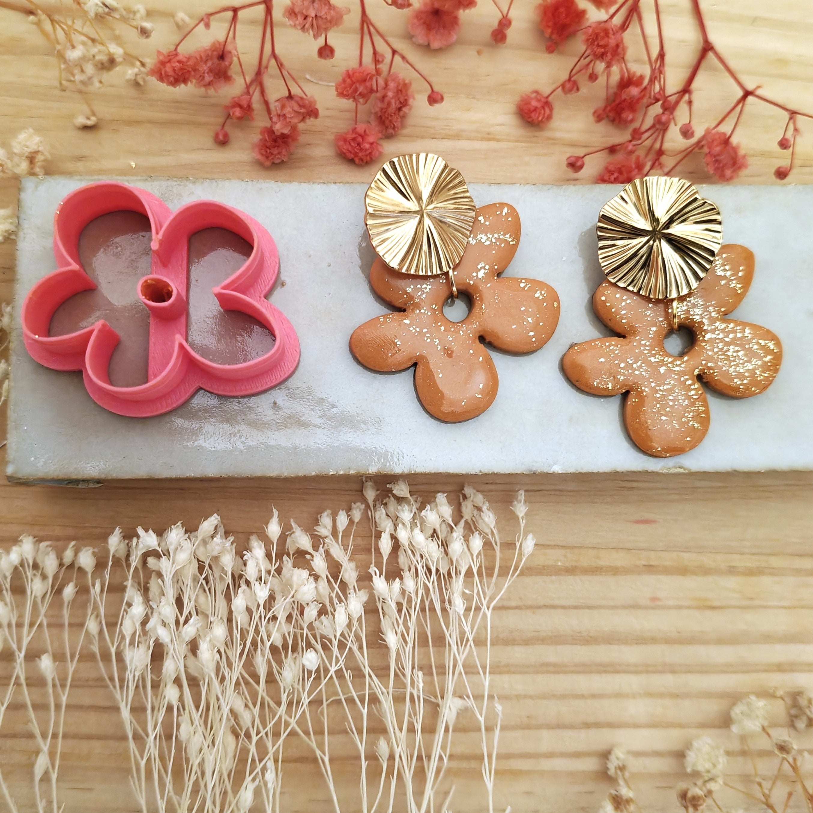 Boucles d'oreilles fleuries DIY réalisées avec l'emporte-pièce Bloom en pâte polymère.